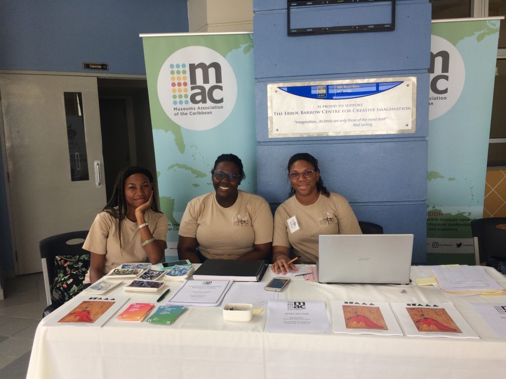 Volunteers at the 2018 MAC Conference table with printed materials. 